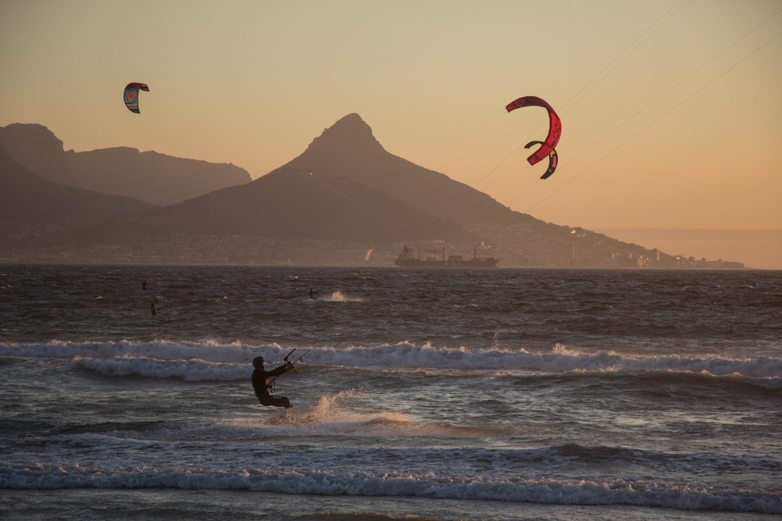 Kitesurfers at Bloubergstrand with Table Mountain behind them