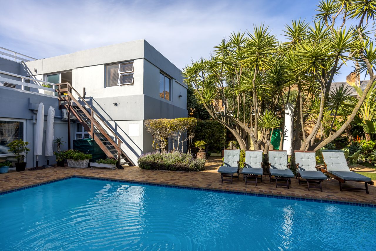Poolside seating at Secret Garden Guesthouse